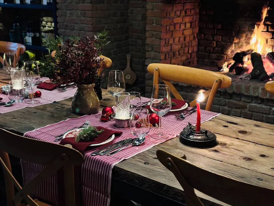 Dinner table by the fireplace at Karnas Vineyards